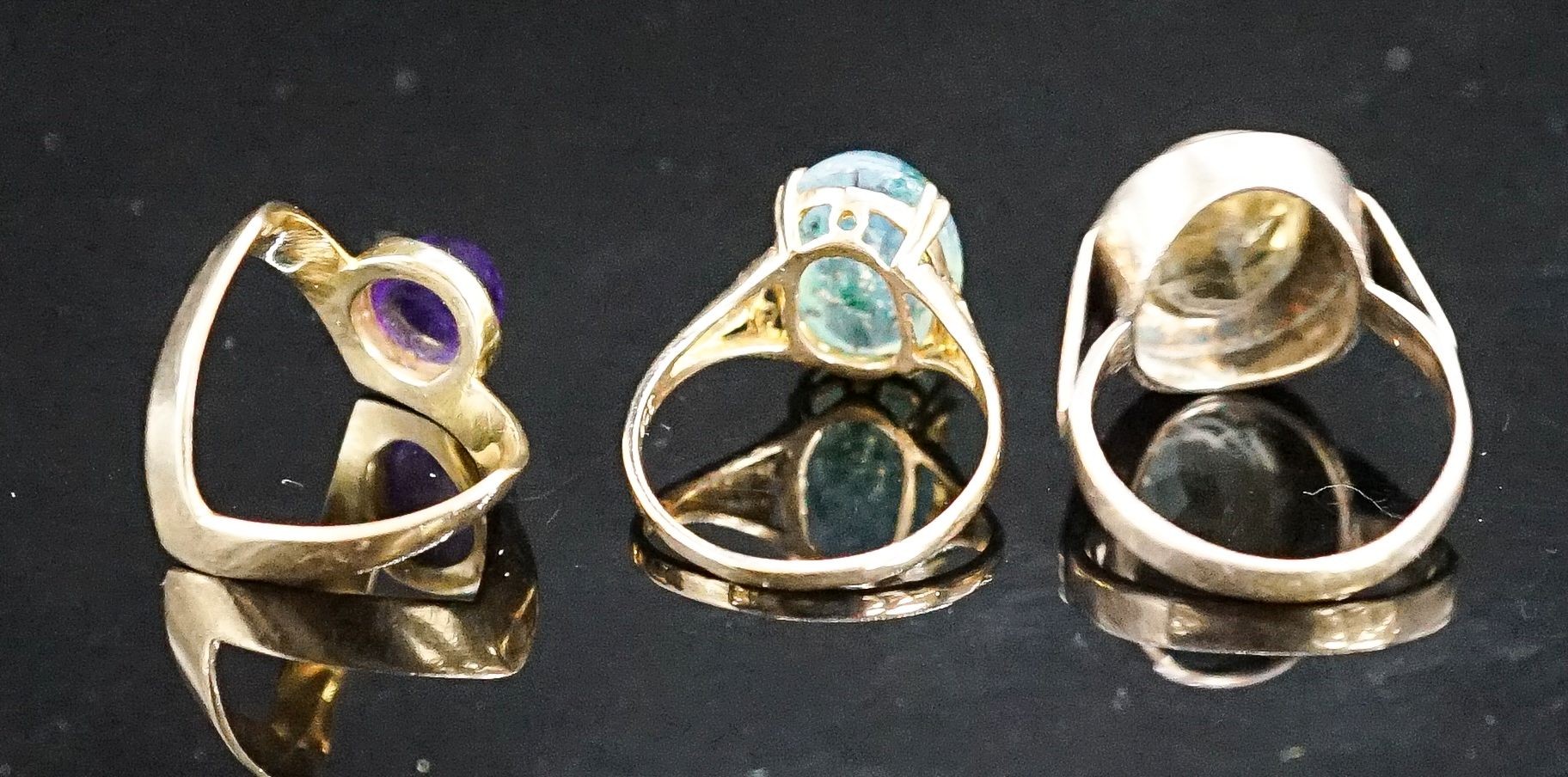 Two 9ct and gem set dress rings, gross 6.8 grams and a 333(8ct) and gem set dress ring, gross 5.6 grams.